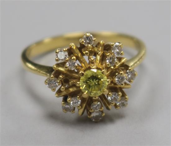 A fancy yellow and colourless diamond star-burst cluster ring, yellow metal shank (two small diamonds missing) size U.